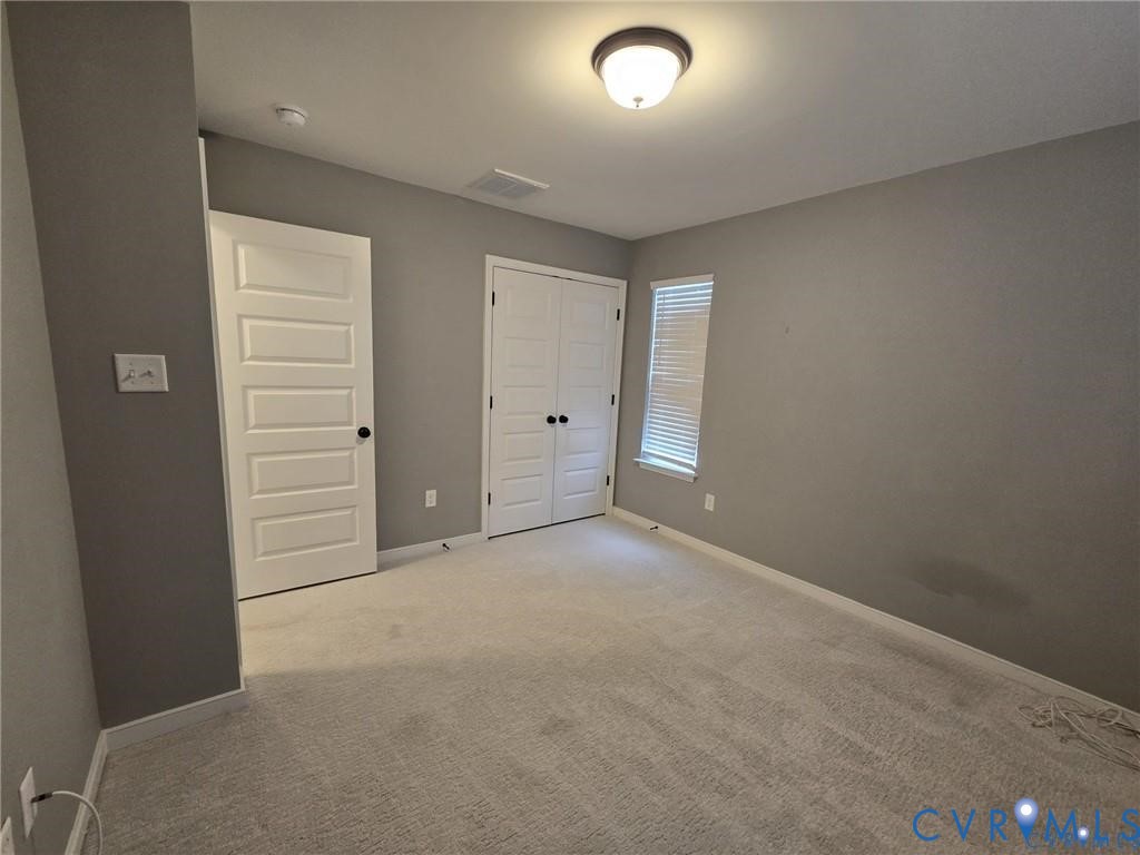 7825 Old Guild Road Richmond, VA 23237 - Photo 23 of 27 Spacious room featuring neutral grey walls and lig