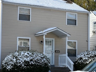 14918 Evers Street Dolton, IL 60419 - Photo 2 of 29 a brick house with a flower garden