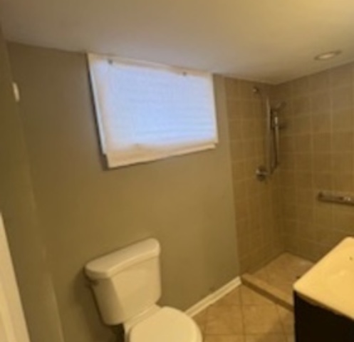 14918 Evers Street Dolton, IL 60419 - Photo 25 of 29 a white toilet sitting next to a bathroom sink