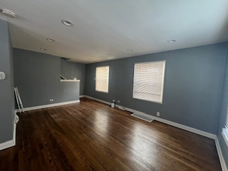 14918 Evers Street Dolton, IL 60419 - Photo 4 of 29 an empty room with wooden floor and windows