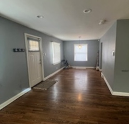 14918 Evers Street Dolton, IL 60419 - Photo 5 of 29 an empty room with wooden floor and windows
