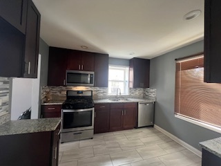 14918 Evers Street Dolton, IL 60419 - Photo 6 of 29 a kitchen with granite countertop stainless steel appliances and cabinets