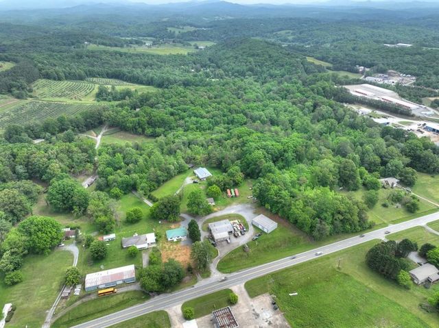 an aerial view of a house with swimming pool garden and patio