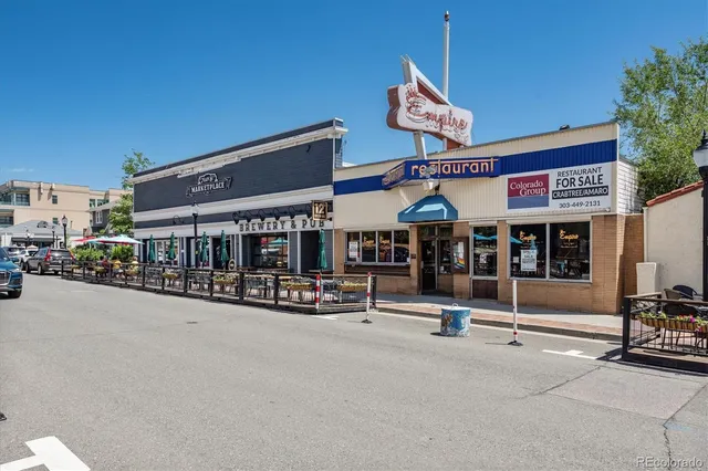 a view of a house with brick walls and flower plants