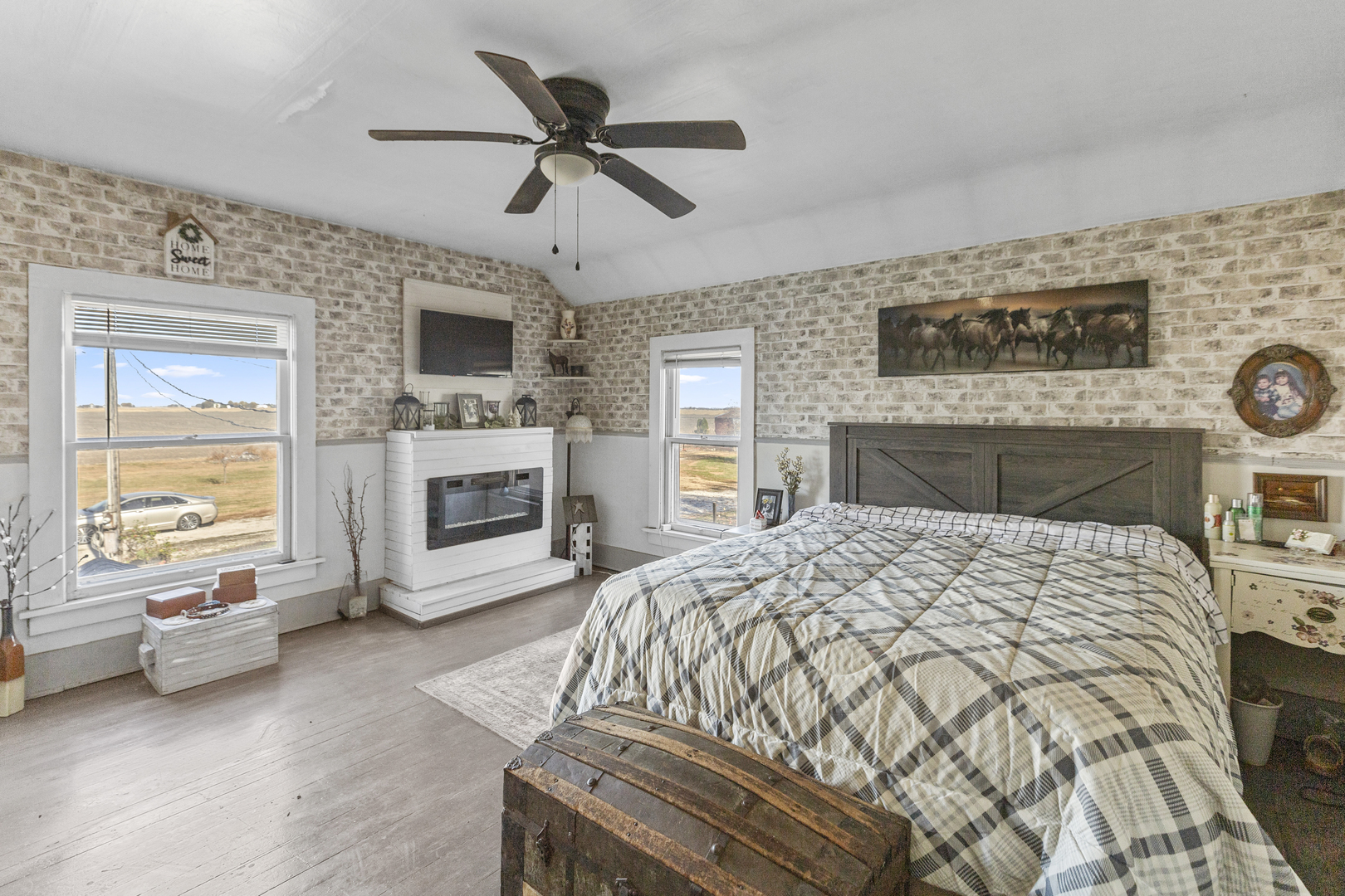 1624 East 1200 North Road Milford, IL 60953 - Photo 25 of 45 a bedroom with a bed a fireplace and a television