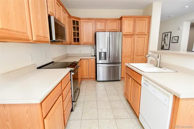 a kitchen with stainless steel appliances granite countertop a refrigerator and a sink