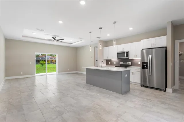 a view of kitchen and kitchen with a sink