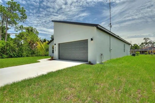 a backyard of a house with plants and garden