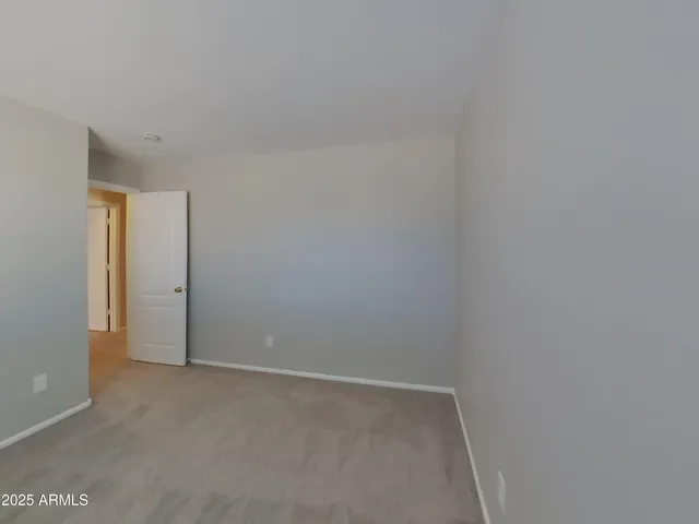 a view of an empty room and a window