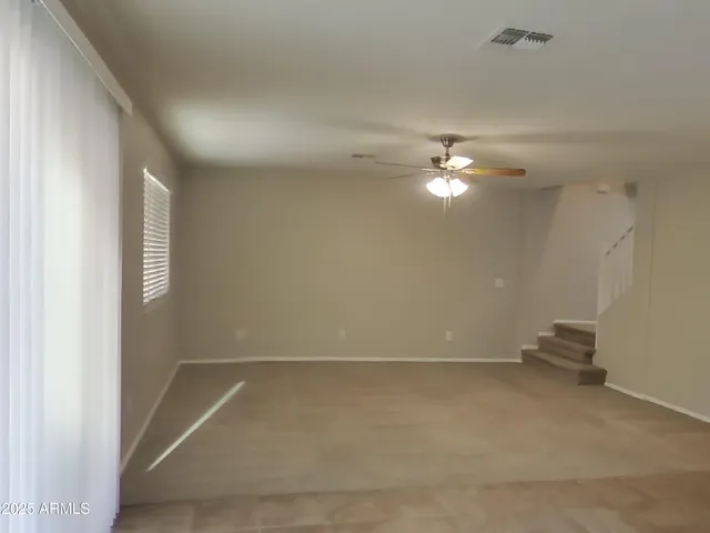 a view of a livingroom with furniture and chandelier fan