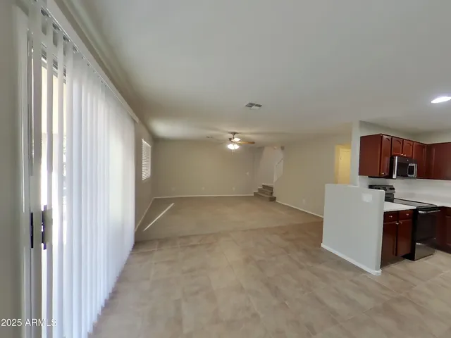a view of a livingroom with a ceiling fan and window