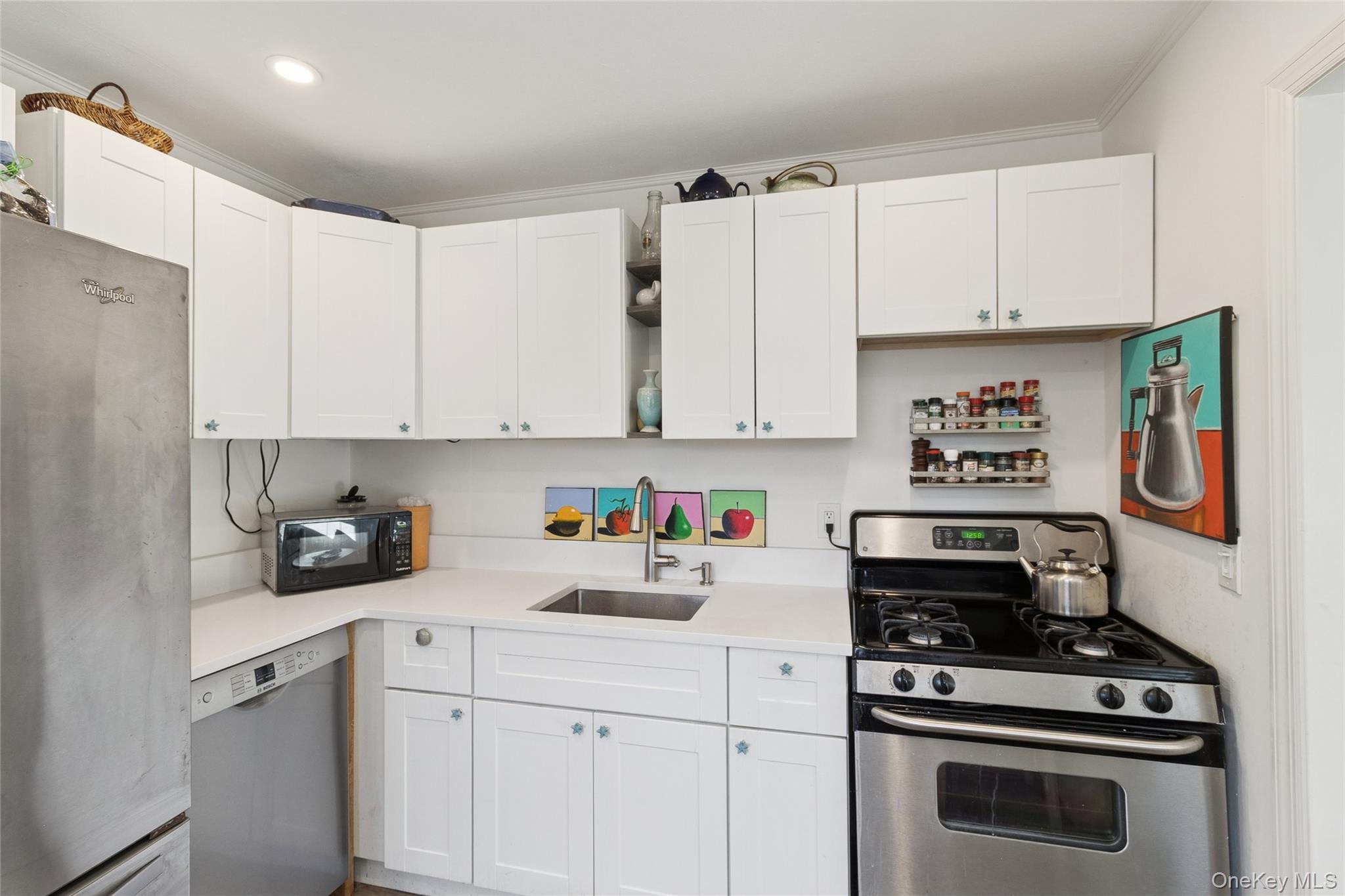 165 Springville Road, Unit A Hampton Bays, NY 11946 - Photo 11 of 22 Kitchen featuring open shelves, appliances with stainless steel finishes, white cabinets, and ornamental molding