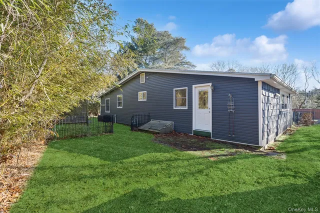 a view of a backyard with potted plants and large tree