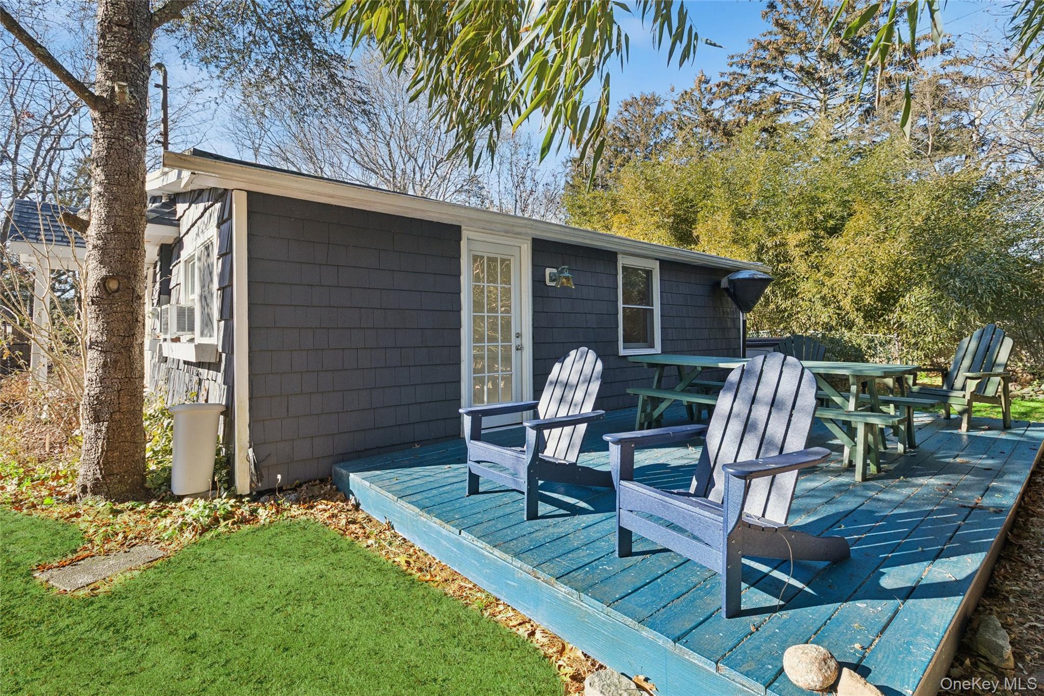 165 Springville Road, Unit A Hampton Bays, NY 11946 - Photo 3 of 22 Wooden terrace with outdoor dining space