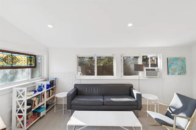 a living room with furniture and a book shelf