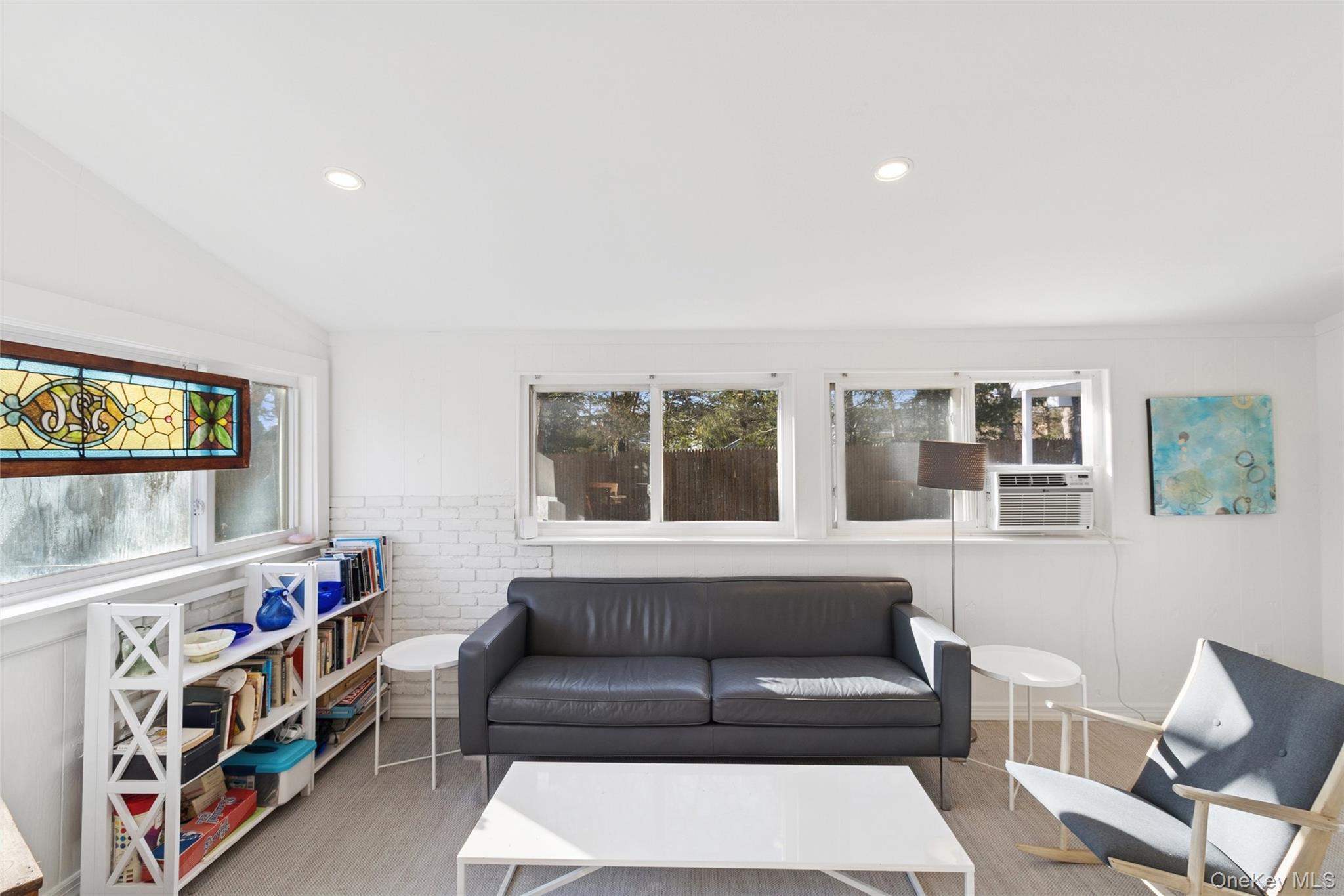 165 Springville Road, Unit A Hampton Bays, NY 11946 - Photo 8 of 22 Living area featuring plenty of natural light, vaulted ceiling, and recessed lighting