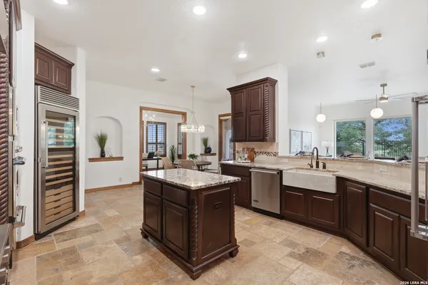 a dining room with furniture a chandelier and a rug