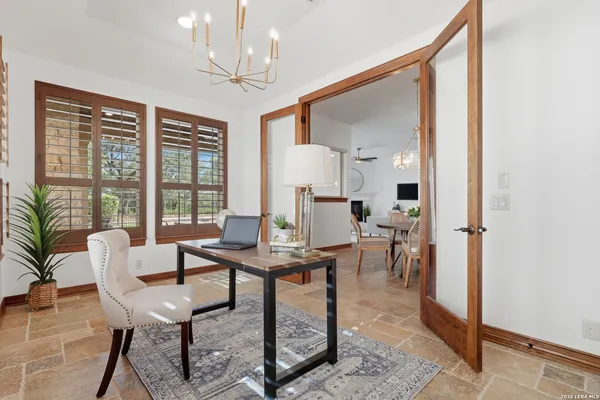 a living room with furniture a fireplace and a large window
