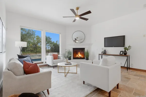 a living room with furniture a window and a fireplace