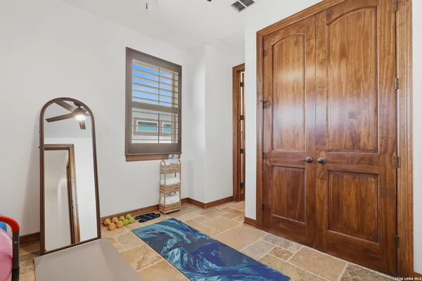 a view of staircase with wooden floor and fan