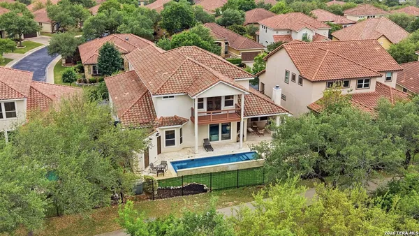 an aerial view of a house with a yard