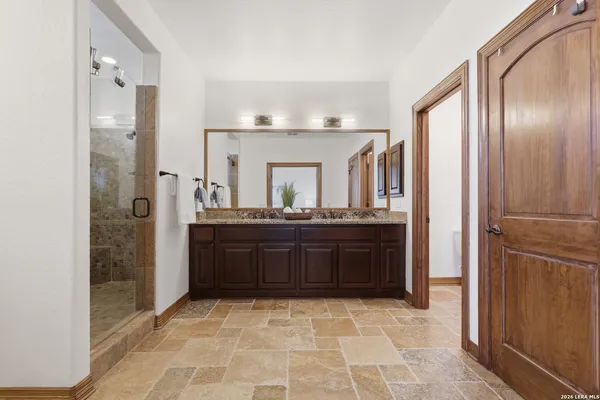a bathroom with a granite countertop sink and a mirror