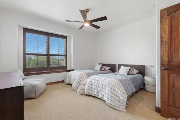 a bedroom with two beds and a window