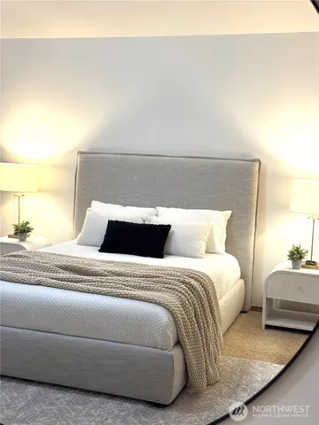 a bedroom with a bed and lamp
