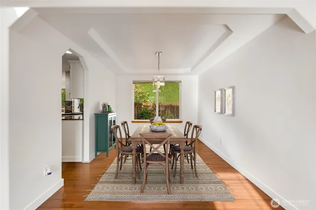 a dining room with furniture a rug and wooden floor