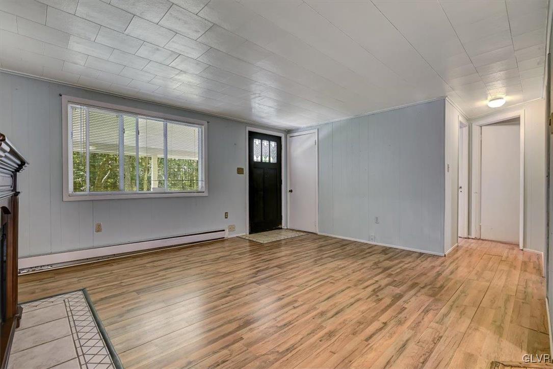 109 Sassafras Road Albrightsville, PA 18210 - Photo 11 of 49 a view of an empty room with wooden floor and a window