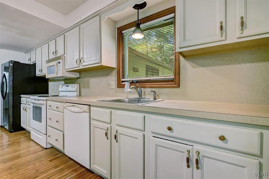 109 Sassafras Road Albrightsville, PA 18210 - Photo 17 of 49 a kitchen with white cabinets and window