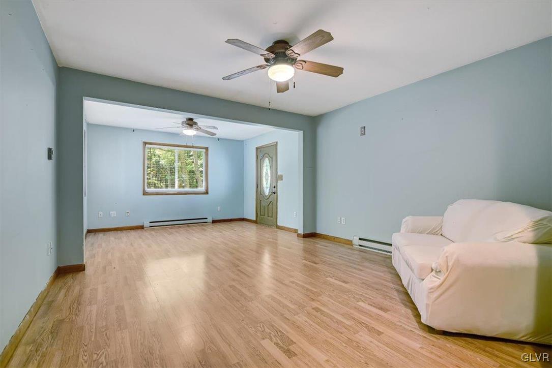 109 Sassafras Road Albrightsville, PA 18210 - Photo 19 of 49 a view of an empty room with a window and wooden floor