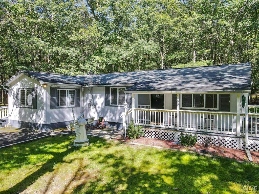 109 Sassafras Road Albrightsville, PA 18210 - Photo 2 of 49 a front view of a house with a yard table and chairs