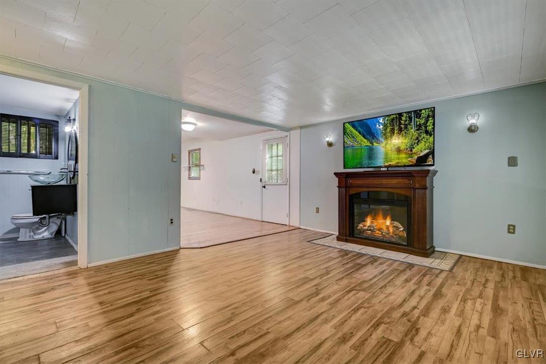 109 Sassafras Road Albrightsville, PA 18210 - Photo 10 of 49 a view of empty room with wooden floor and fireplace