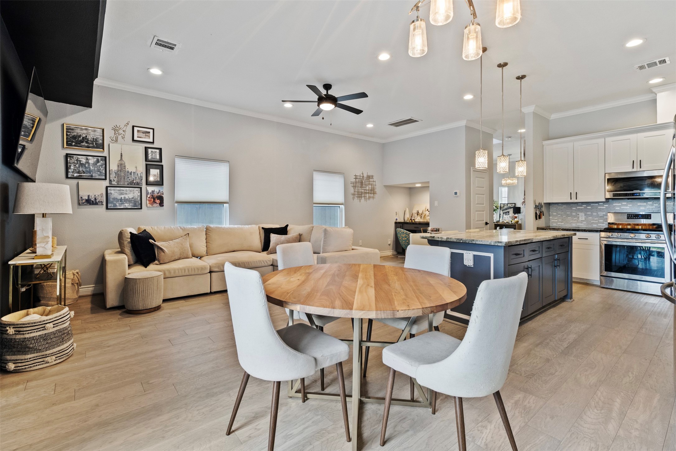 6706 Lozier Street Houston, TX 77021 - Photo 22 of 32 a living room with furniture a dining table and a chandelier