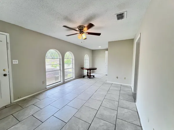 a view of a livingroom with a window and a ceiling fan