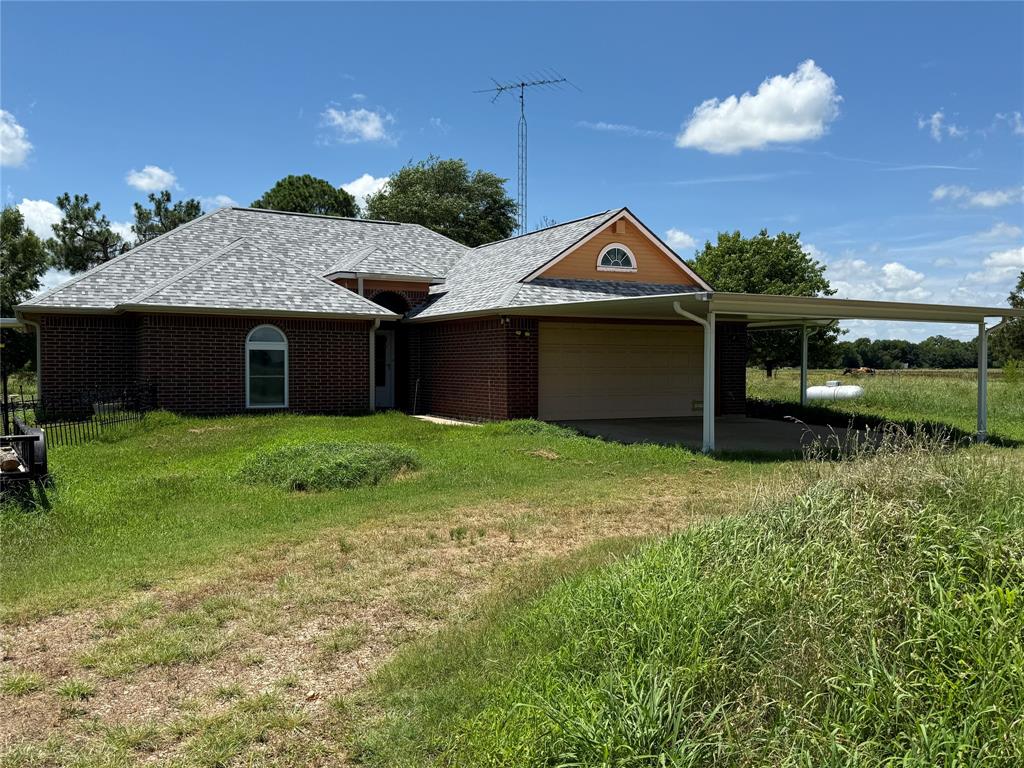 3016 County Road 4405 Commerce, TX 75428 - Photo 1 of 40 a front view of a house with garden