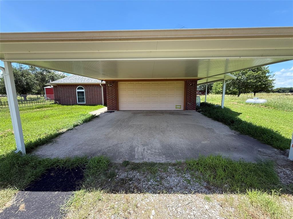 3016 County Road 4405 Commerce, TX 75428 - Photo 19 of 40 a view of a back yard of the house
