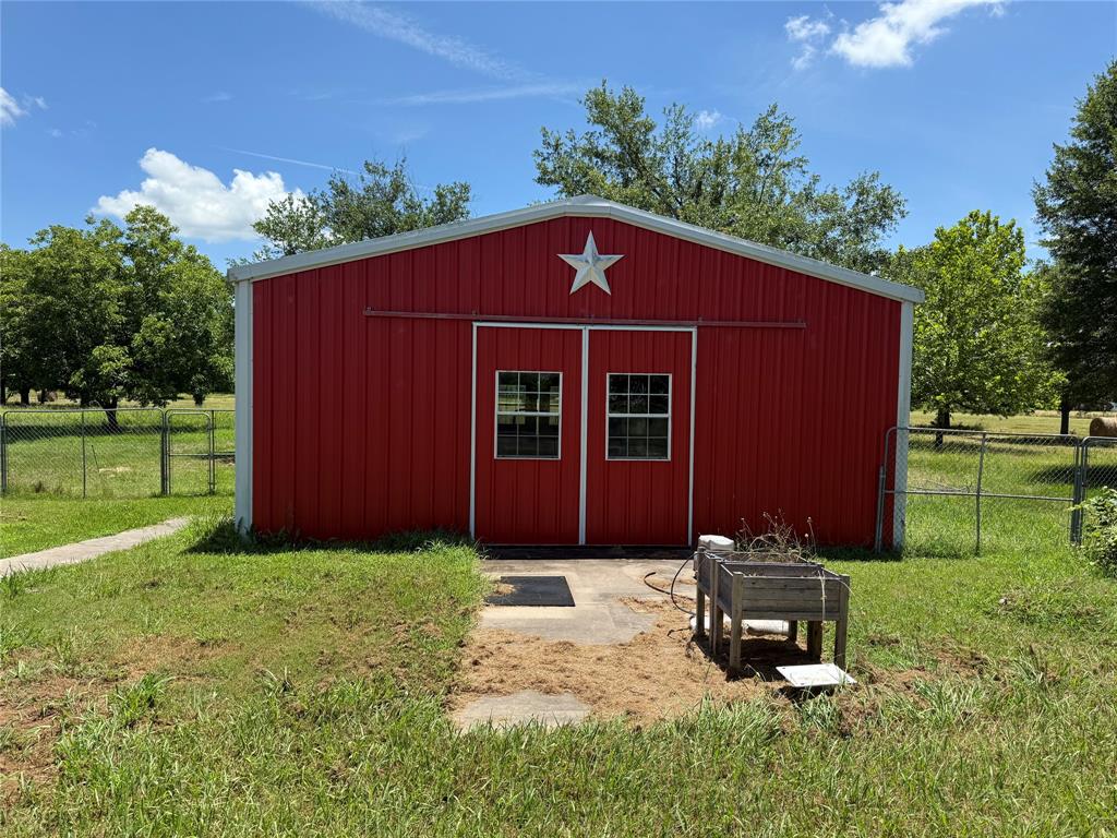 3016 County Road 4405 Commerce, TX 75428 - Photo 25 of 40 a view of a small house with a yard