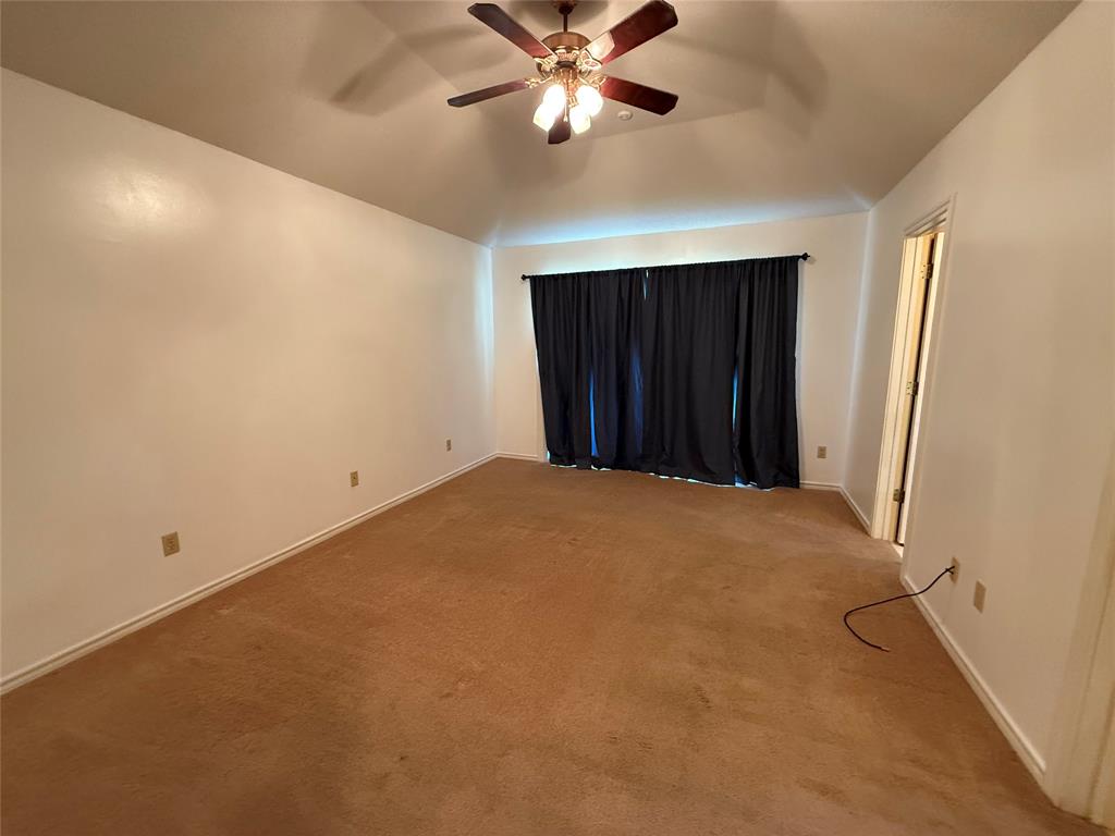 3016 County Road 4405 Commerce, TX 75428 - Photo 3 of 40 an empty room with closet and a ceiling fan