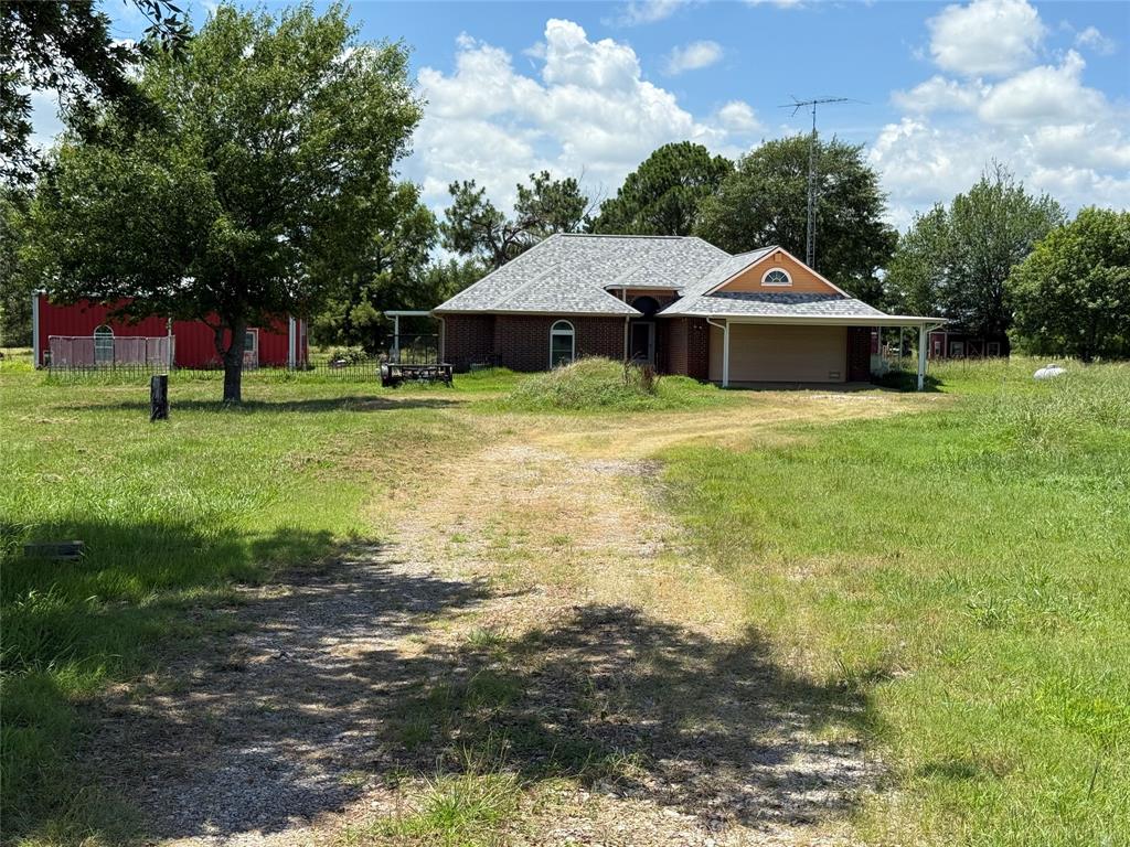 3016 County Road 4405 Commerce, TX 75428 - Photo 33 of 40 a front view of a house with a yard