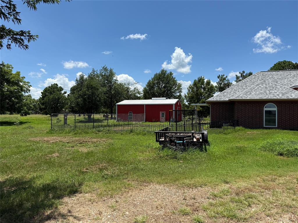 3016 County Road 4405 Commerce, TX 75428 - Photo 36 of 40 a front view of a house with a garden and outdoor seating