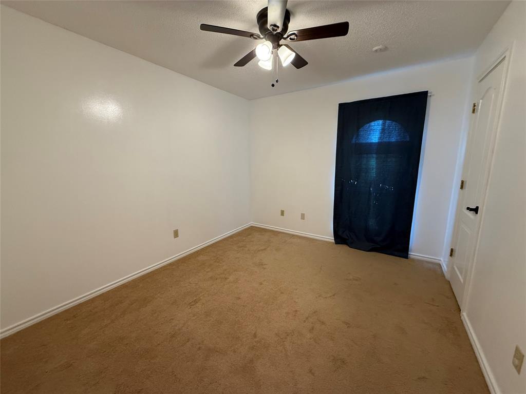 3016 County Road 4405 Commerce, TX 75428 - Photo 4 of 40 an empty room with closet and a ceiling fan