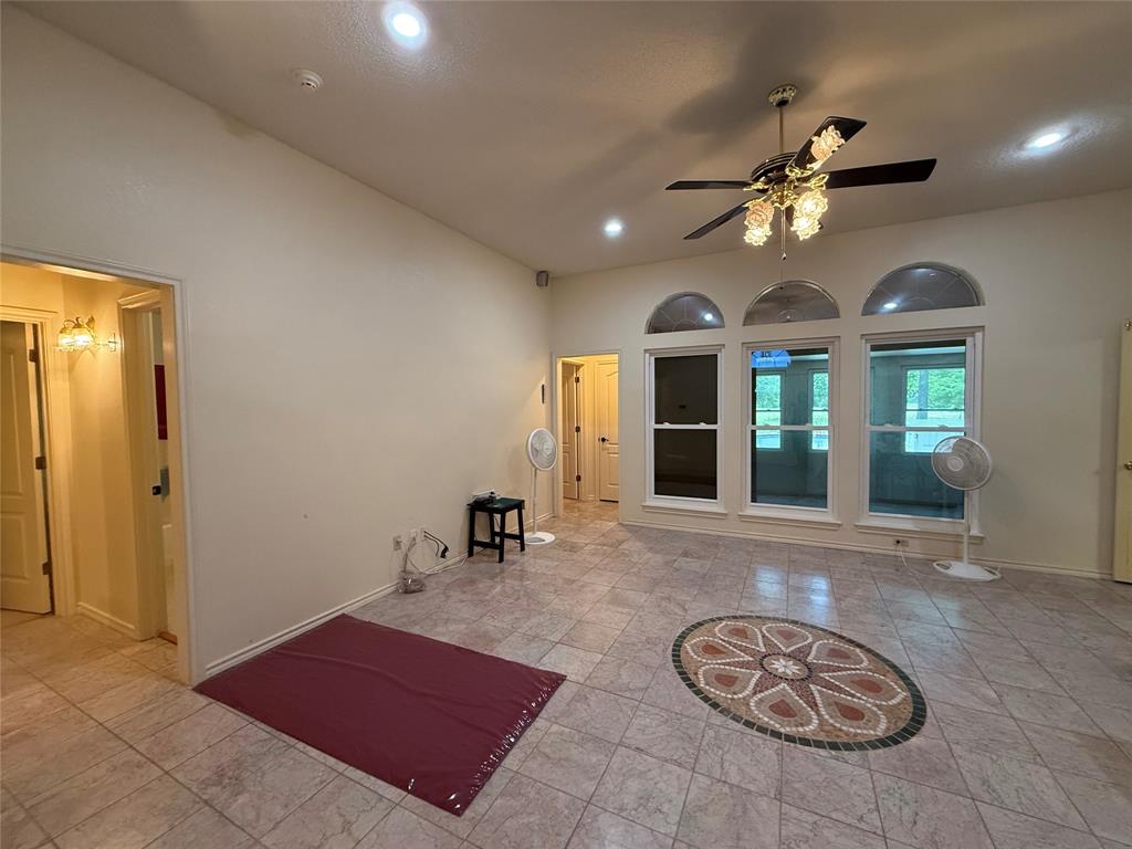 3016 County Road 4405 Commerce, TX 75428 - Photo 5 of 40 a view of a livingroom with furniture and a ceiling fan