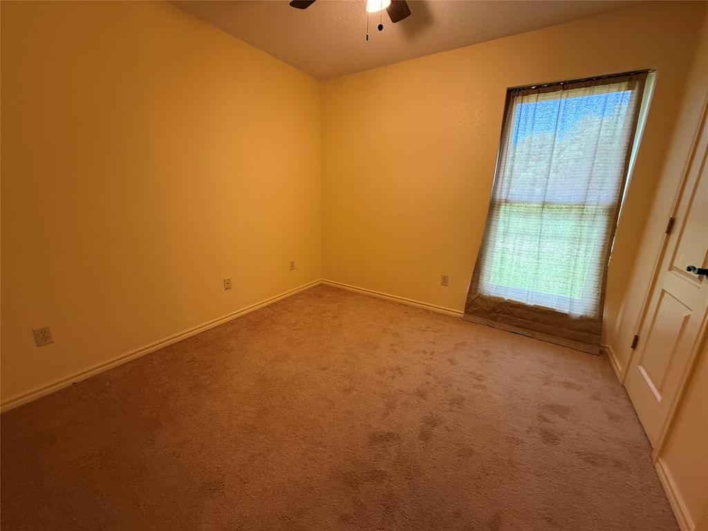 3016 County Road 4405 Commerce, TX 75428 - Photo 8 of 40 an empty room with a window