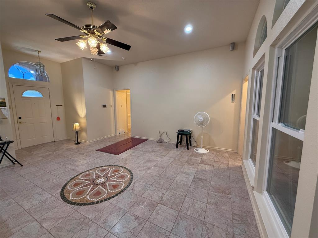 3016 County Road 4405 Commerce, TX 75428 - Photo 10 of 40 a view of a hallway with a chandelier