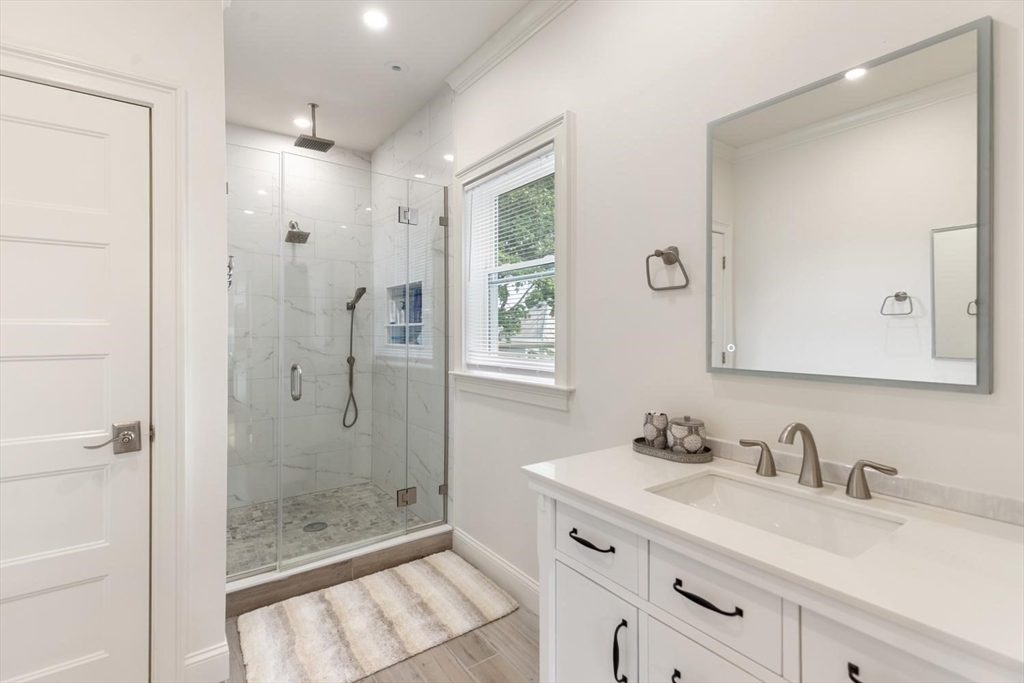 155 Adams Avenue Newton, MA 02465 - Photo 25 of 37 a bathroom with a granite countertop sink mirror and double