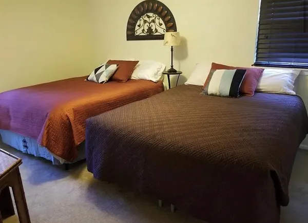 a bedroom with a bed and a night stand