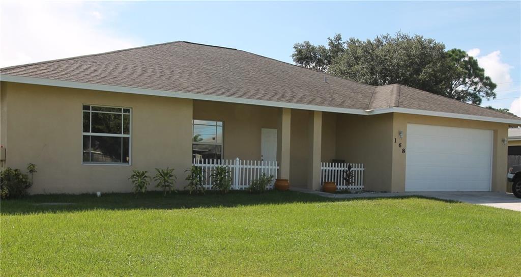 168 Southwest Ridgecrest Drive Port St. Lucie, FL 34953 - Photo 1 of 17 a front view of house with yard