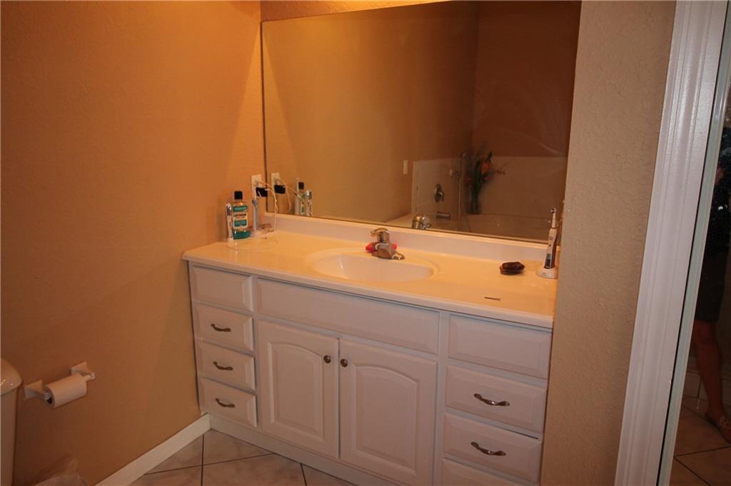168 Southwest Ridgecrest Drive Port St. Lucie, FL 34953 - Photo 13 of 17 a bathroom with a sink and a mirror